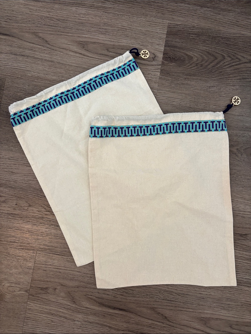 Set of 2 Tory Burch drawstring dust bags, canvas with gold charm